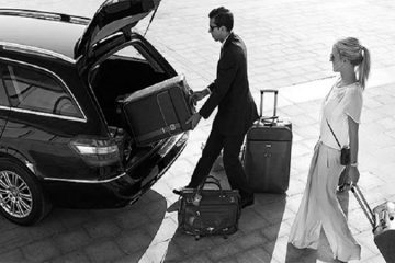Brisbane chauffeur placing baggage into limousine