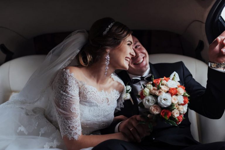 bride and groom in car