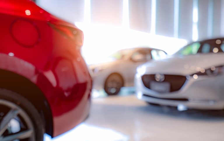 white and red luxury car parked