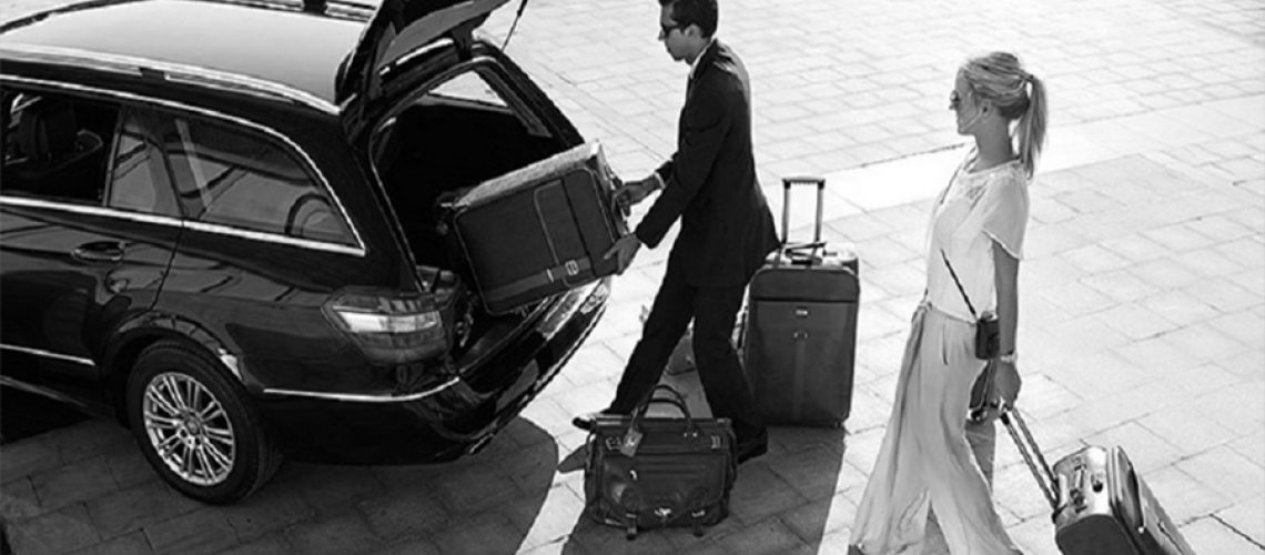 Brisbane chauffeur placing baggage into limousine